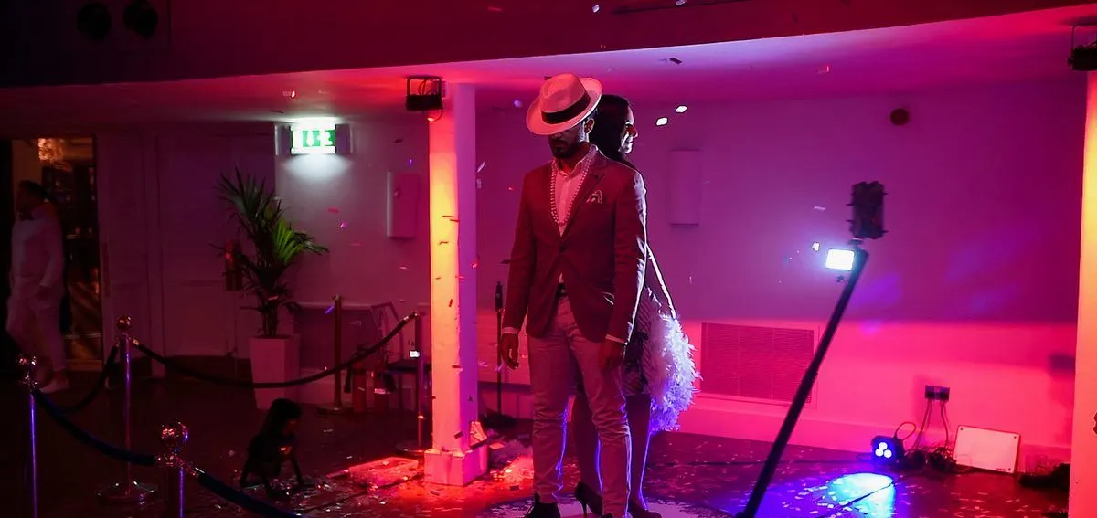 Guest on the 360 photo booth platform under event lighting
