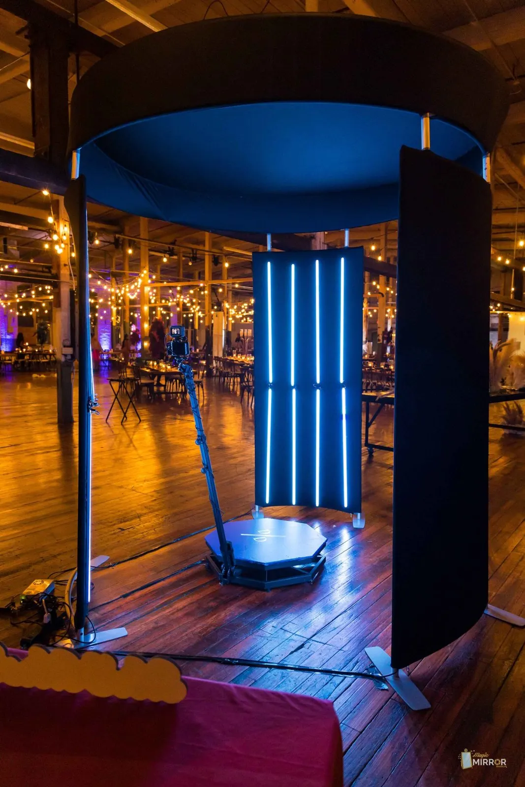 Crowd watching a 360 booth session at an evening event