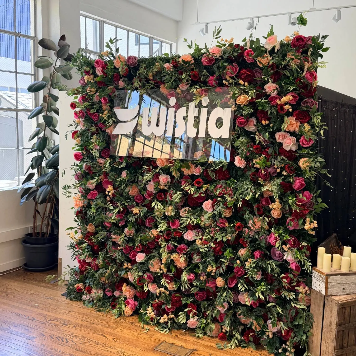 Deep-toned floral wall styled for an evening event