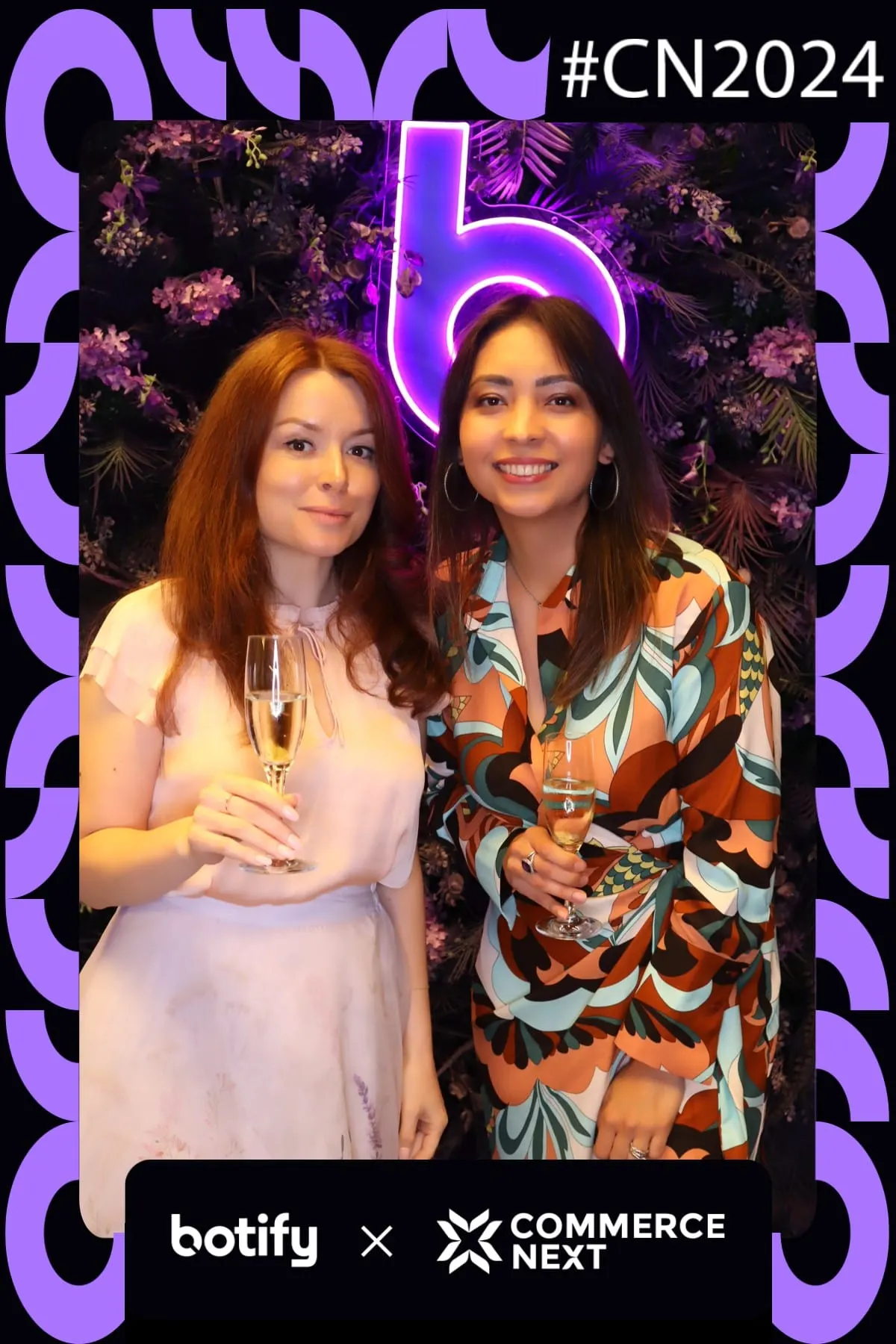 Two guests toasting with champagne at the Botify x CommerceNext photo booth