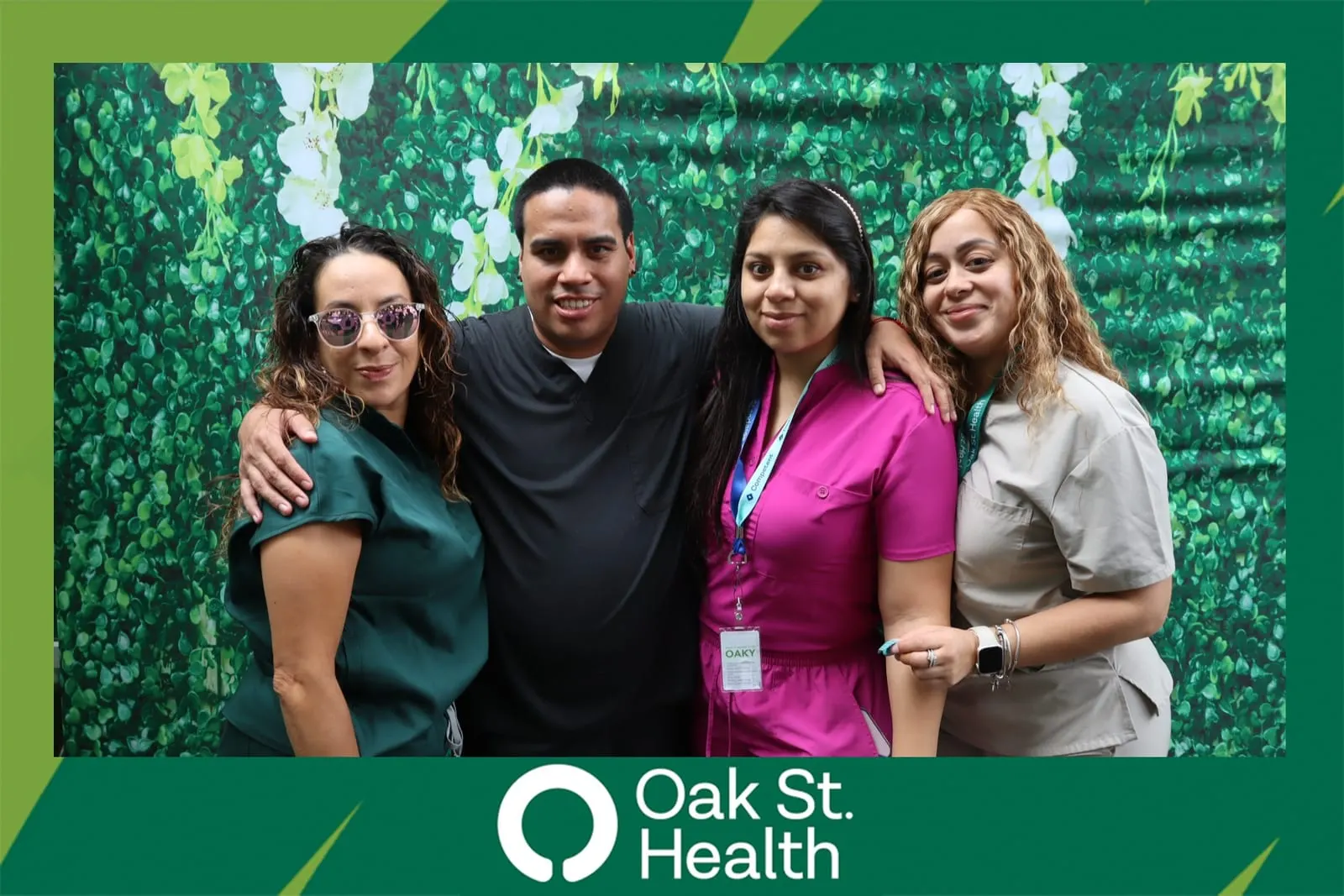 Couple posing together at the Oak St. Health flower wall booth