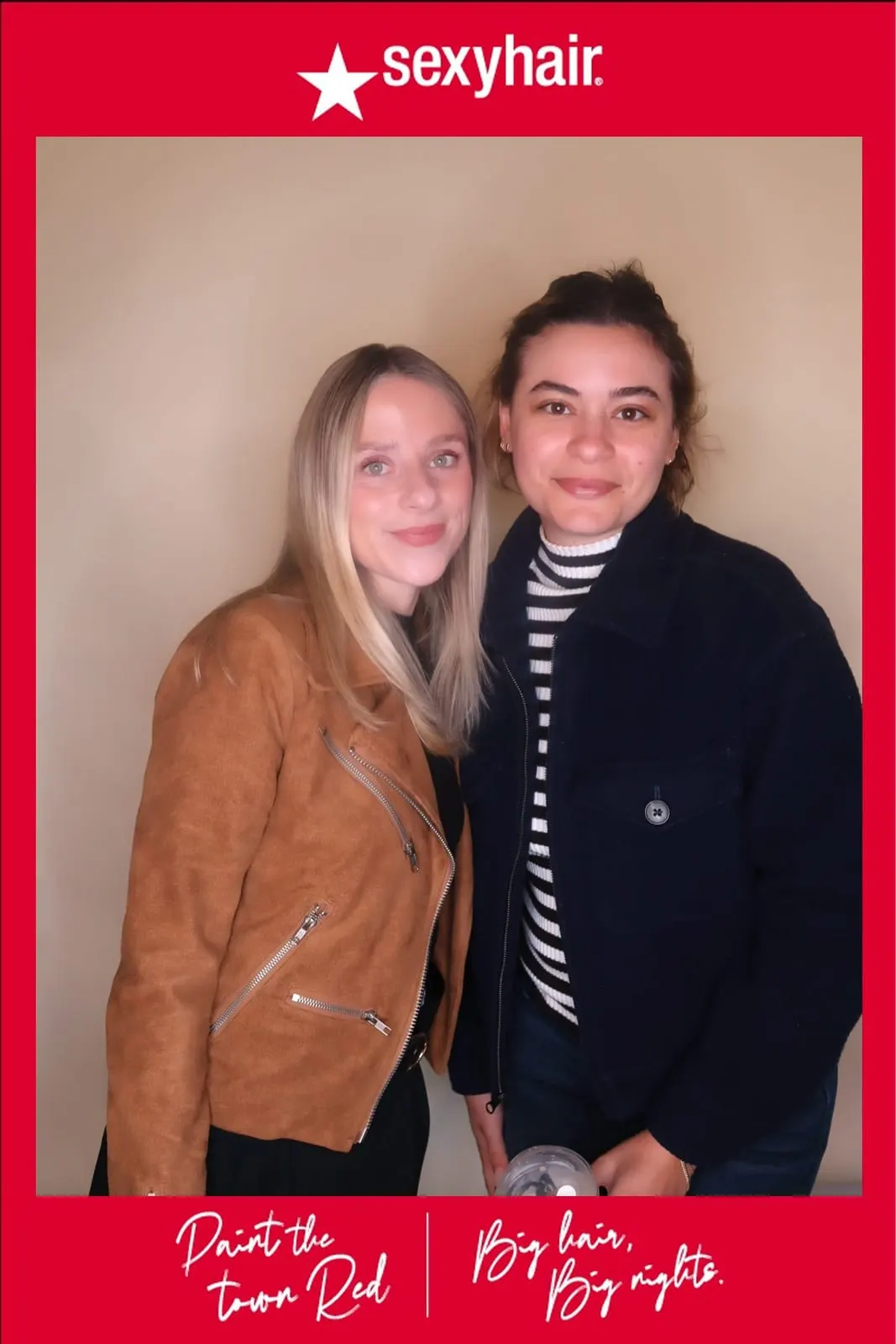 Two SexyHair team members posing together at the Paint the Town Red activation