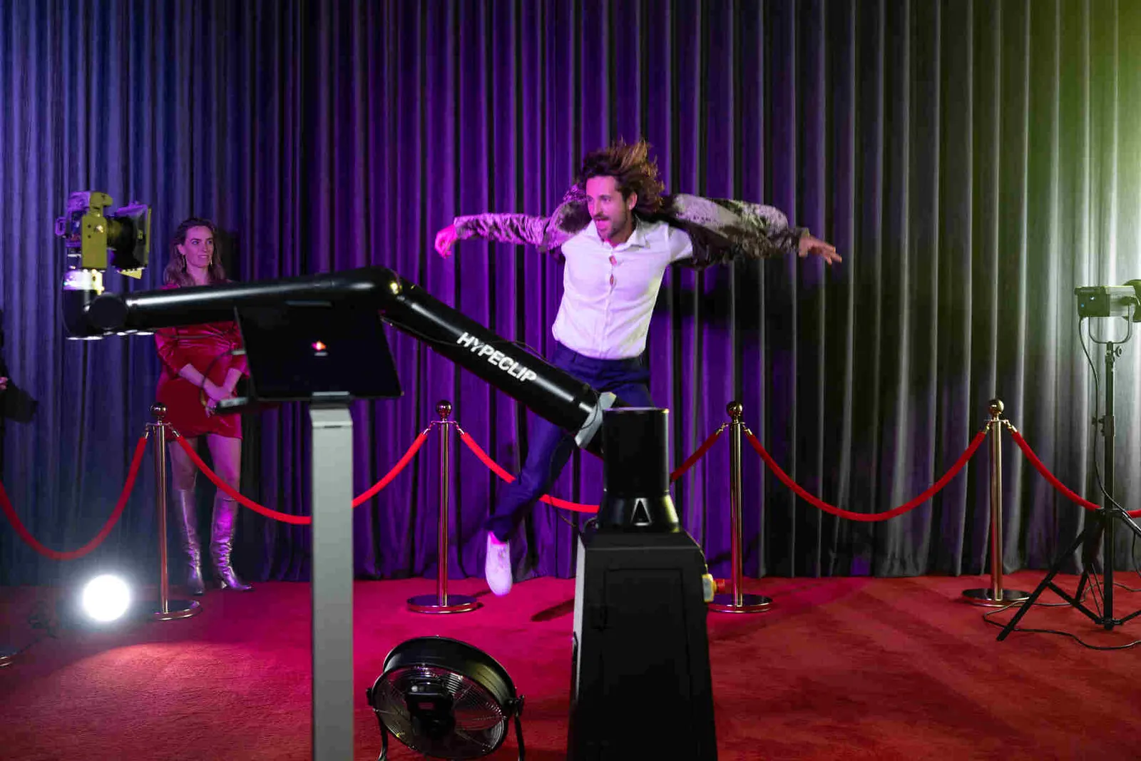 Robotic camera arm capturing a slow-motion sweep at an evening event