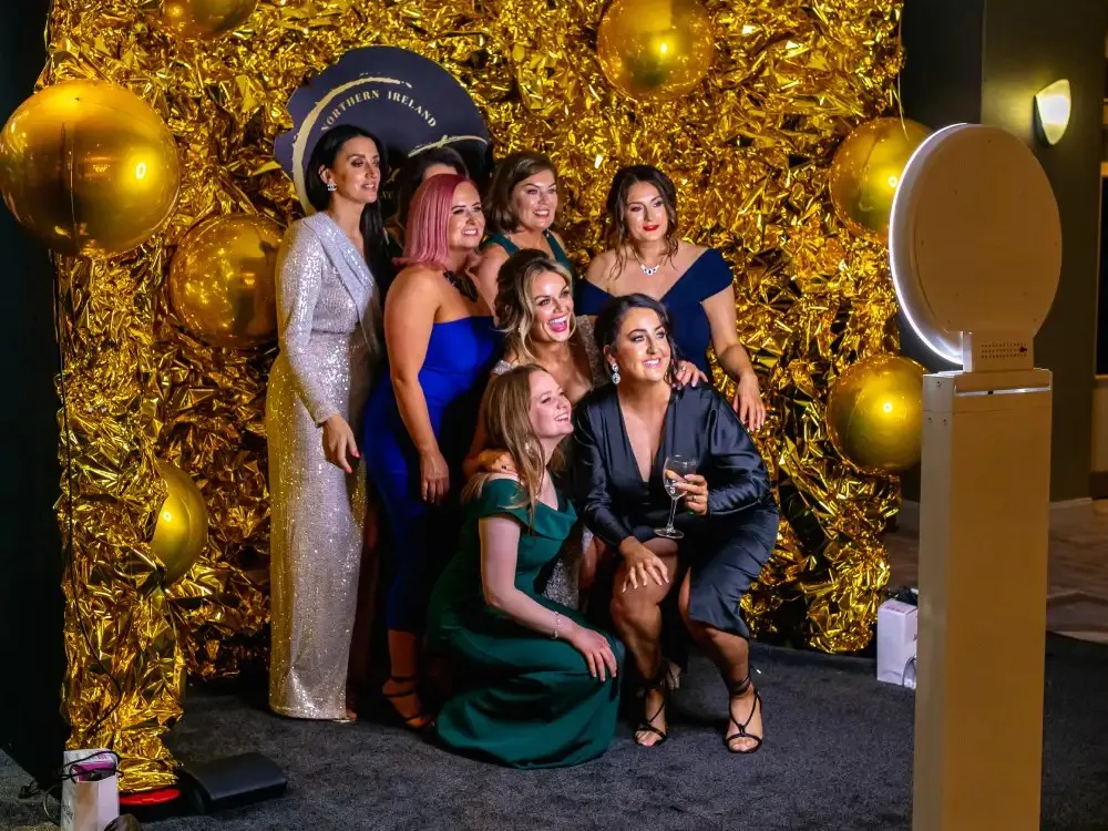 Guests photographed against a gold textured backdrop
