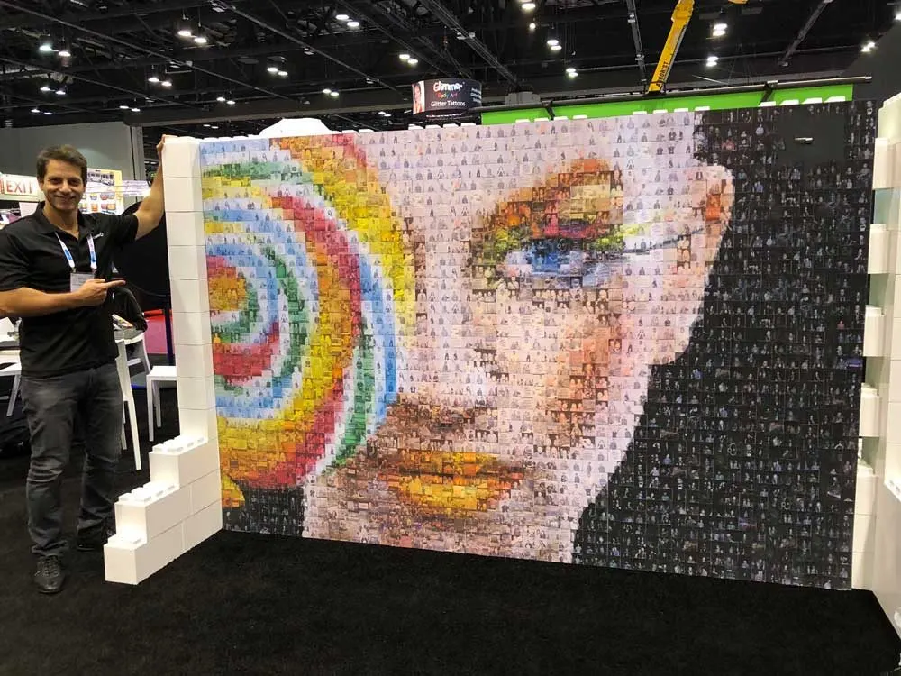 Guest placing a photo sticker on a mosaic wall