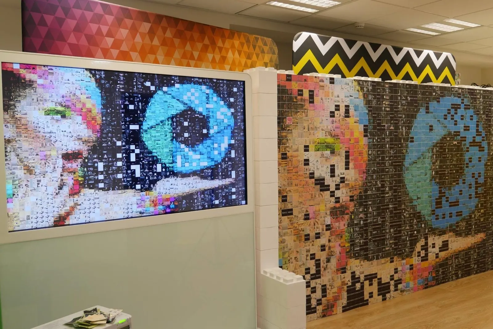 Guests placing photo stickers on a live mosaic wall at an event