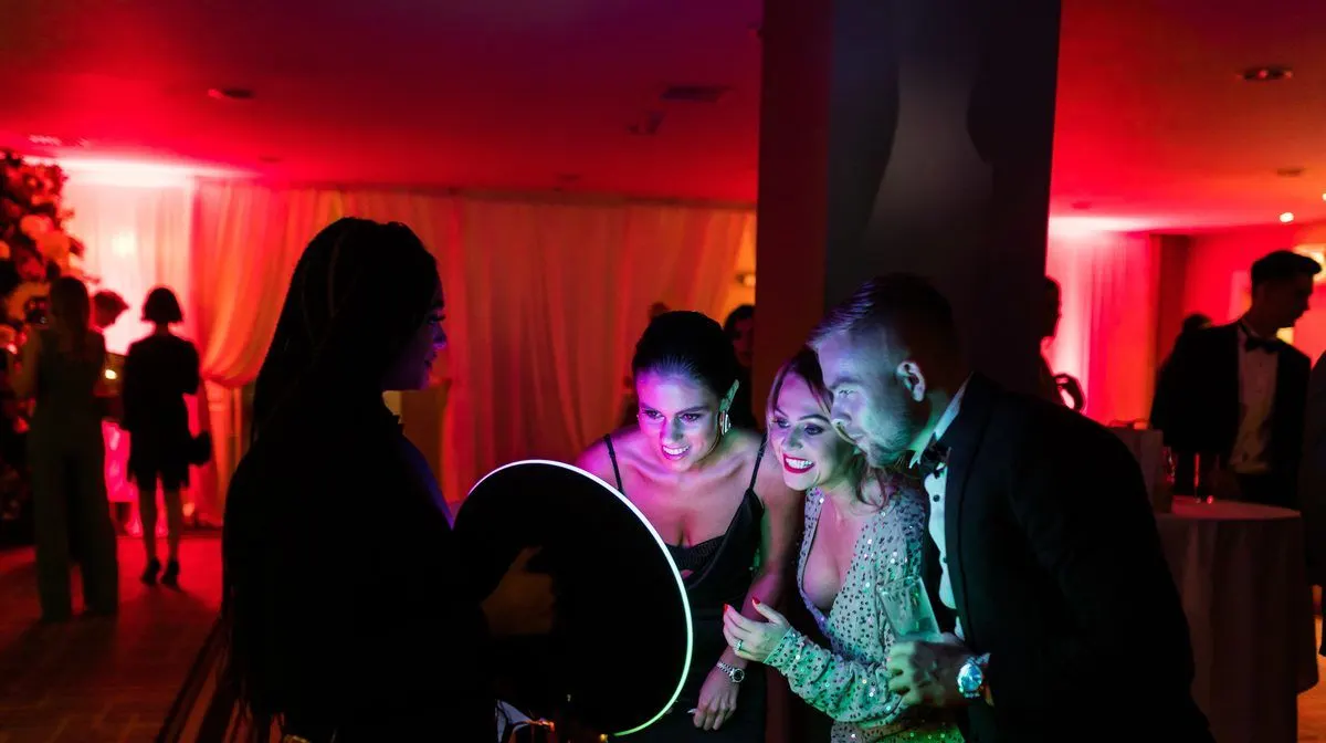 Roaming photo booth attendant capturing guests at a reception