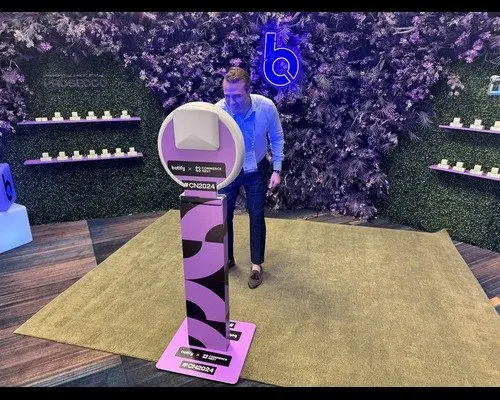 Attendees using a branded booth on a trade show floor