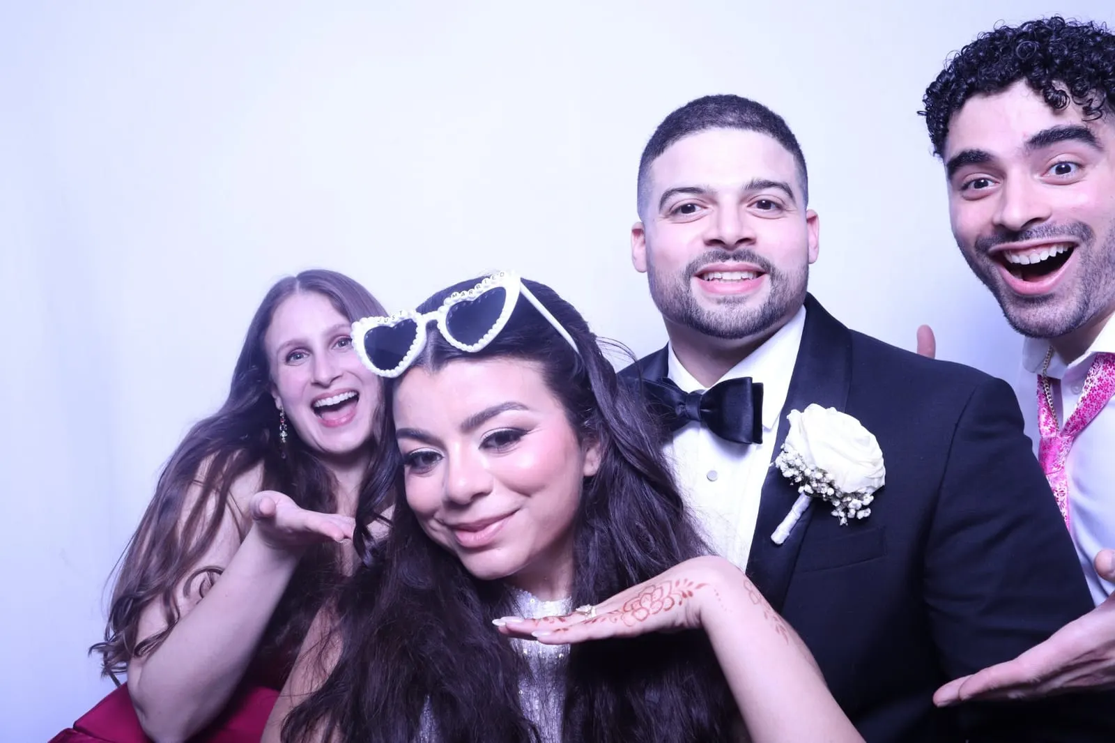 Wedding photo booth setup with a floral backdrop