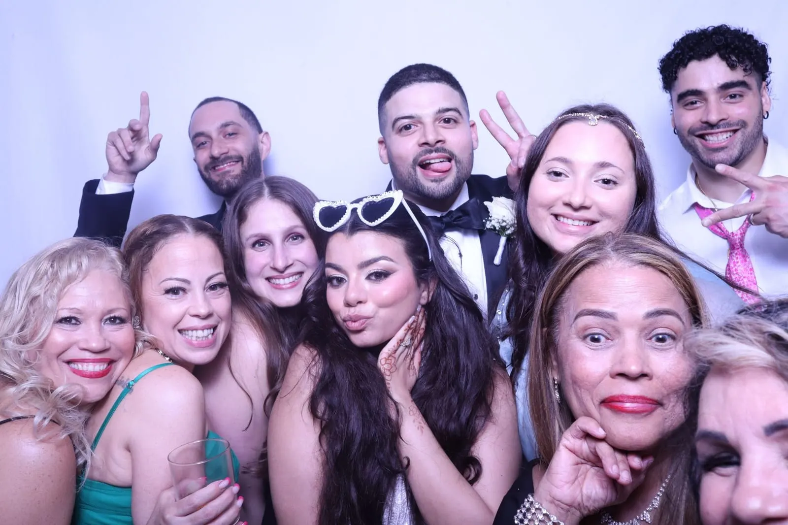 Guests posing at a wedding photo booth